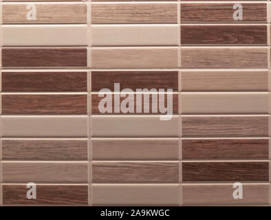 wall covered with rectangular ceramic tiles with various wood textures drawn Stock Photo