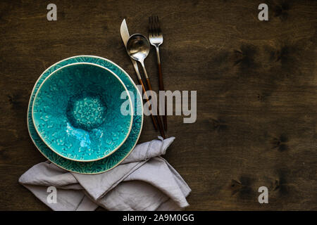 Rustic table setting with bright colored ceramic plates Stock Photo