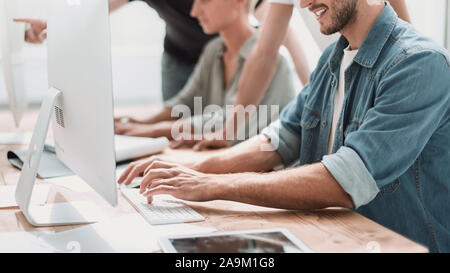 close up. a young man analyzing the information coming into the office Stock Photo