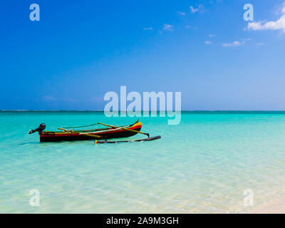 Colorful fishermen pirogue moored on turquoise sea of Nosy Ve island, Indian Ocean, Madagascar Stock Photo