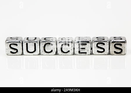 Success concept with cubic metal letters on white background Stock Photo