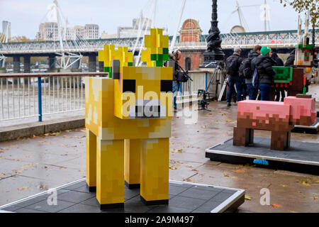 London, UK. 16th November 2019. In Celebration of Minecraft Earth Rollout, one-of-a-kind, life-sized statues of interactive mobs popping up in London.  The statues are life-sized creations of the Muddy Pig, Moobloom and festive Jolly Llama which feature a scannable QR code to play an exclusive new adventure built by the Minecraft Earth development team. The London mobs can be scene along The Queens Walk weekends from November 16 to December 1st.  Credit: JF Pelletier / Alamy Live News Stock Photo