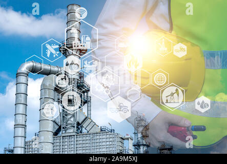 Double exposure of engineer holding walkie talkie are working orders the oil and gas refinery plant. Industry petrochemical concept image and icon con Stock Photo