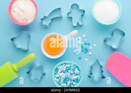 ingredients and cookie cutter on blue background, flat lay Stock Photo