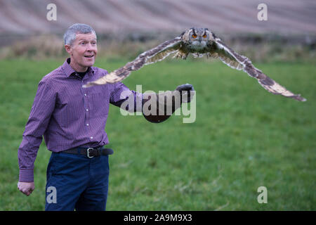 Glasgow, UK. 16 November 2019.   Pictured: Willie Rennie MSP - Leader of the Scottish Liberal Democrat Party, posing with Sage the Owl.  Scottish Liberal Democrat Leader Willie Rennie visits the Falconry centre in Cluny to highlight the threat Brexit poses on the environment and biodiversity loss. Credit: Colin Fisher/Alamy Live News Stock Photo