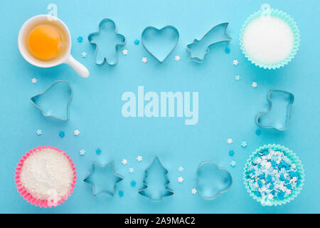 ingredients and cookie cutter on blue background, flat lay Stock Photo