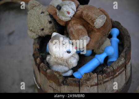 Abandoned teddy bear in the trash can. The symbol of leaving childhood ...