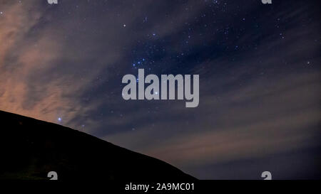 The constellation Orion over the Clywdian Range AONB in North Wales Stock Photo
