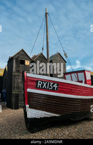 Fishing boat and traditional net huts, Hastings Old Town, The Stade, Rock a Nore, Hastings, East Sussex, UK Stock Photo