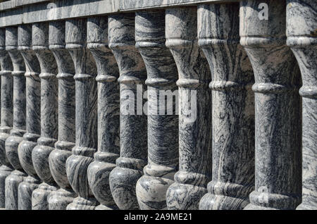 Beautiful gray marble balustrade illuminated by the bright sun. Stone background Stock Photo