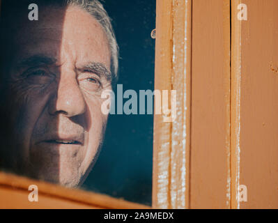 Senior man looking through the window. Stock Photo