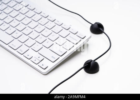 White Laptop And Adhesive Cable Organizer Isolated On White Background Stock Photo