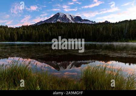WA17292-00...WASHINGTON - Sunrise at reflection Lakes with Mount Rainer reflected in the calm water. Mount Rainier National Park. Stock Photo