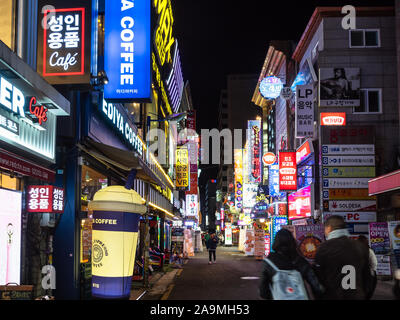 SEOUL, SOUTH KOREA - NOVEMBER 3, 2019: people walk on shopping and restaurant street in Myeongdong district in Seoul at night. Seoul Special City is t