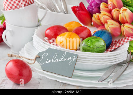 German Invitation Easter Decoration Breakfast Table Red Tulips with red Easter Eggs as Background Stock Photo