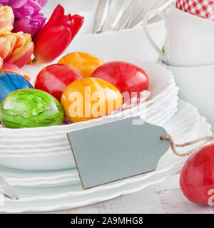Easter Decoration Breakfast Table Red Tulips with red Easter Eggs as Background Stock Photo