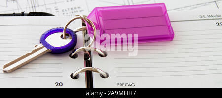 Calendar with key fob close-up as background Stock Photo