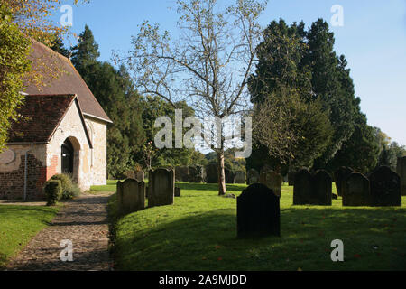 Path leading to the east entrance of St. Mary's Church, Selborne, Hampshire: a quiet scene in the churchyard Stock Photo