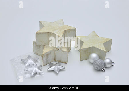 Three big wooden Stars with silver Christmas decorations, close up, isolated on white Background Stock Photo