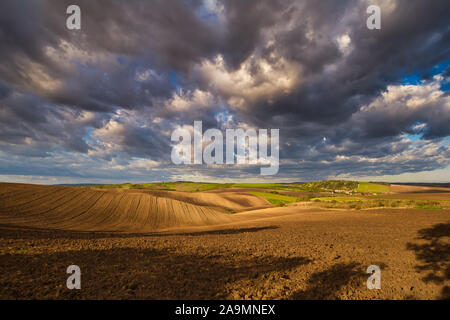 Rolling fields of South Moravia in the autumn morning with a sky full of fast-moving clouds after a storm, Moravian Tuscany, Czechia Stock Photo