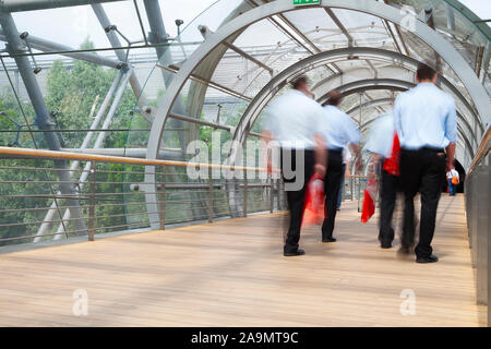 Business people walking through the tunnel, modern architecture Stock Photo