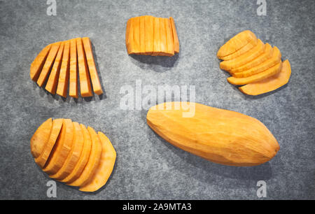 Fresh sweet potatoes on baking paper, selective focus. Stock Photo