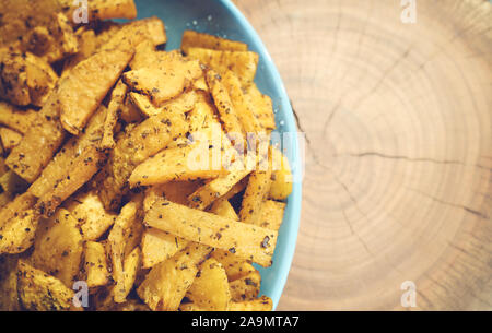 Roasted sweet potatoes with herbs, selective focus, space for text. Stock Photo