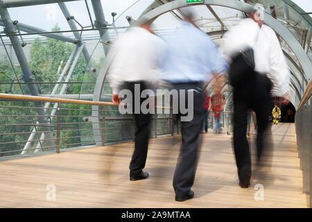 Business people walking through the tunnel, modern architecture Stock Photo