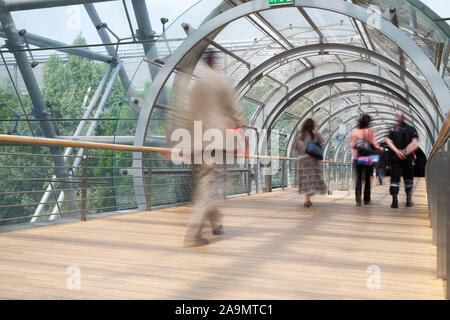 Business people walking through the tunnel, modern architecture Stock Photo