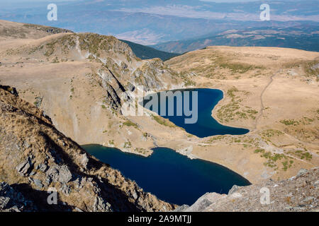 Top view of two glacial blue watered lakes, part of the circus of the Seven Rila Lakes, Kidney Lake and above it Okoto lake, Rila mountain, Bulgaria.
