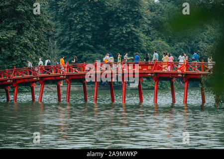 Hanoi, Vietnam - 12th October 2019: The bright Red Huc Bridge over Hoan Kiem Lake in Hanoi Stock Photo