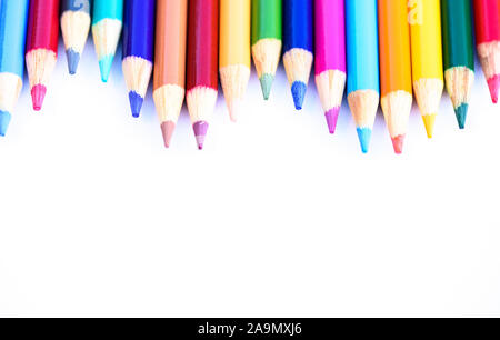 bright vibrant colored pencils in line on white background Stock Photo