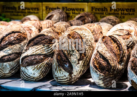 Fresh rustic loaves of bread at Buns & Buns restaurant, Covent Garden Market, London, UK Stock Photo