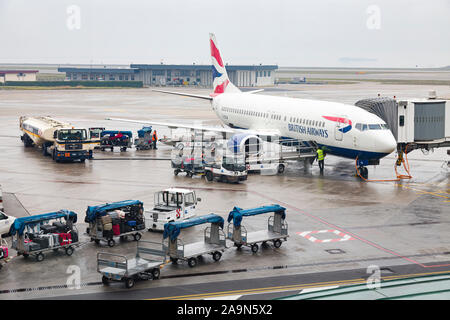 VENICE, ITALY - December 26, 2012. Baggage handlers load luggage onto a British Airways plane at Venice Marco Polo Airport, Venice, Italy Stock Photo