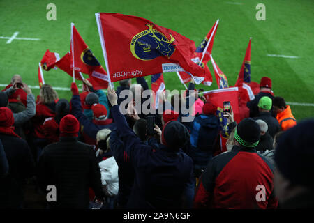 Swansea, UK. 16th Nov, 2019. Munster Rugby supporters wave their flags. Heineken champions cup match, pool 4, Ospreys v Munster rugby at the Liberty Stadium in Swansea, South Wales on Saturday 16th November 2019. pic by Andrew Orchard/ Credit: Andrew Orchard sports photography/Alamy Live News Stock Photo