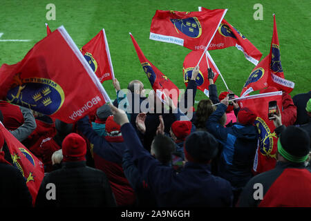 Swansea, UK. 16th Nov, 2019. Munster Rugby supporters wave their flags. Heineken champions cup match, pool 4, Ospreys v Munster rugby at the Liberty Stadium in Swansea, South Wales on Saturday 16th November 2019. pic by Andrew Orchard/ Credit: Andrew Orchard sports photography/Alamy Live News Stock Photo