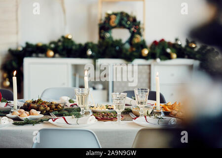 Background image of beautiful table setting for Christmas party with fir elegant candles and delicious homemade food, copy space Stock Photo