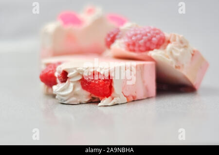 Handmade pink soap.Cold Processed Handcrafted Soap.Home made soap look like cake, ice cream with berries,glitter on gray background with sparkles Stock Photo