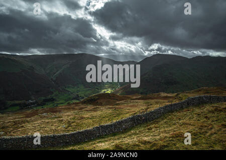 Sun breaking through rainy clouds over Kirkstone Pass, view from the top of Gale Crag in Lake District, UK Stock Photo