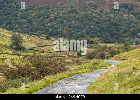Scenic countryside road across Hartsop Valley at autumn in Lake District National Park, UK Stock Photo