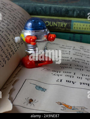 Tomy windup robot on an old reader Stock Photo