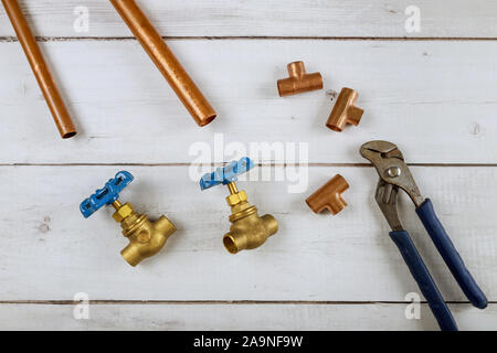 Brass gate valve on wooden background, monkey wrench brass plumbing fittings Stock Photo