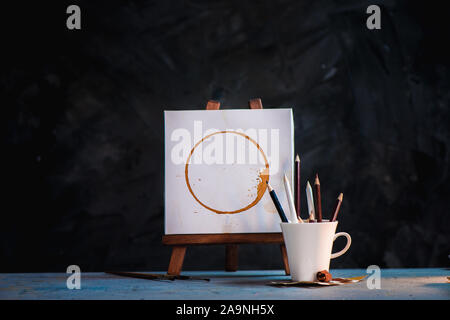 Coffee for inspiration concept, cups, and pencils on a dark background with copy space Stock Photo