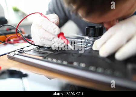 Man soldering laptop parts Stock Photo