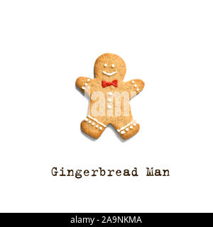 Gingerbread man isolated on white background. Trendy Christmas minimal composition - homemade gingerbread man cookie, top view, copy space. Stock Photo