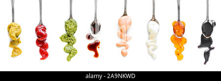 Sauces Assortment. Set of various sauces on spoons. Popular sauces isolated on white, top view, copy space. Homemade sauces set. Stock Photo