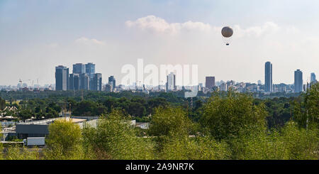 tel aviv city skyline from the university campus with yarkon park and ayalon highway in the middle ground and a hot air balloon in the sky Stock Photo