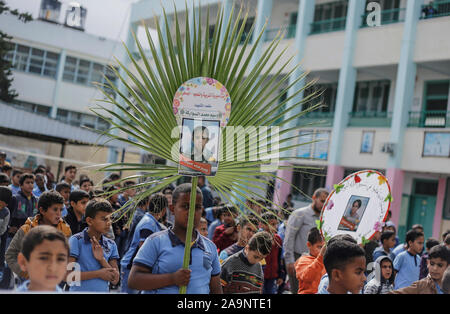 Gaza, Palestine. 16th Nov, 2019. Palestinian students hold pictures of the members of the Sawarka family who were killed during an Israeli air strike in Deir al-Balah.Israel said it targeted the Sawara family and killed seven people by mistake. Human rights groups have criticised previous IDF investigations into possible war crimes in the Gaza Strip. Credit: SOPA Images Limited/Alamy Live News Stock Photo