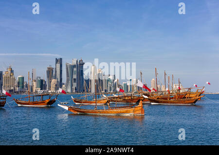 Traditional Arabic Dhow boats with Qatar flags in Doha, Qatar National day preparation. Doha, Qatar, Middle East. Stock Photo