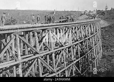 Industries of War - Lumbering - TRACK LAYING ON LINE SOUTH near Beaver Creek, rail laying from hand car on bridge ca. 1915-1920 Stock Photo